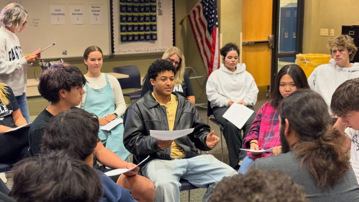 West Ottawa High School students participate in a classroom discussion while seated in a circle.