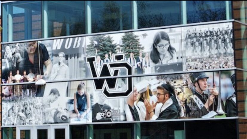 Entrance to West Ottawa High School with pictures of students engaged in different activities