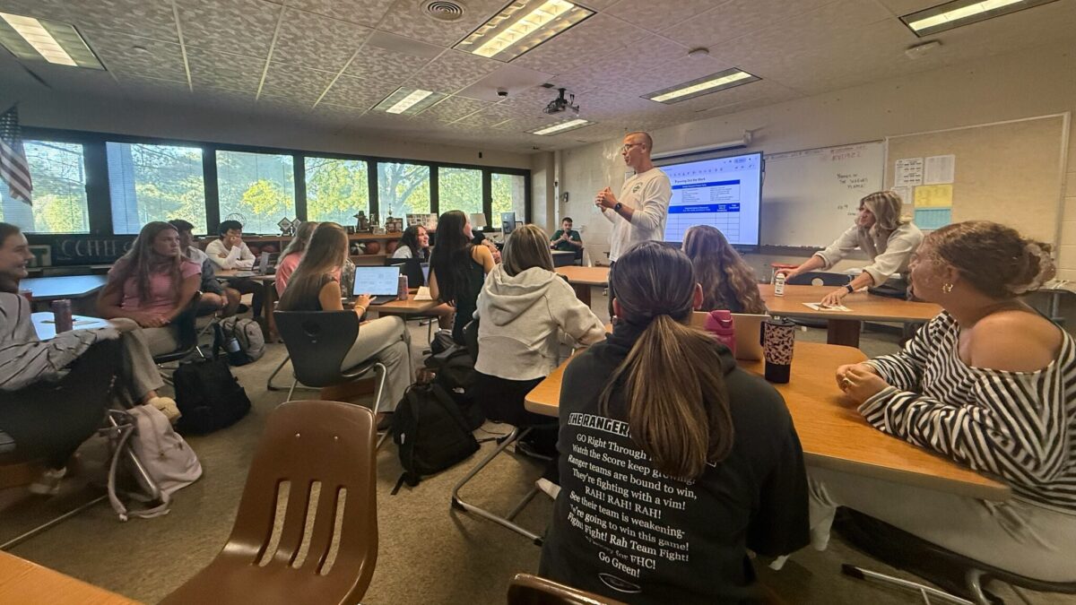 School leader speaks with Forest Hills Central students during a classroom visit.