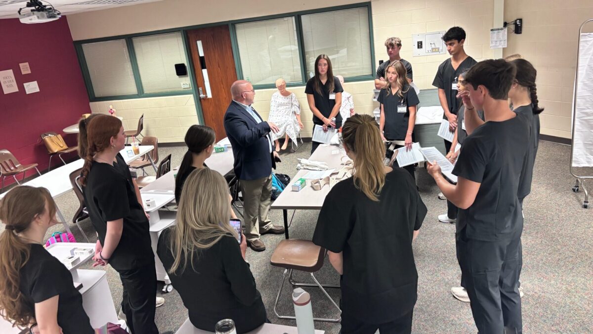 Colin Ripmaster speaks with Forest Hills Central students during a hands-on learning activity.