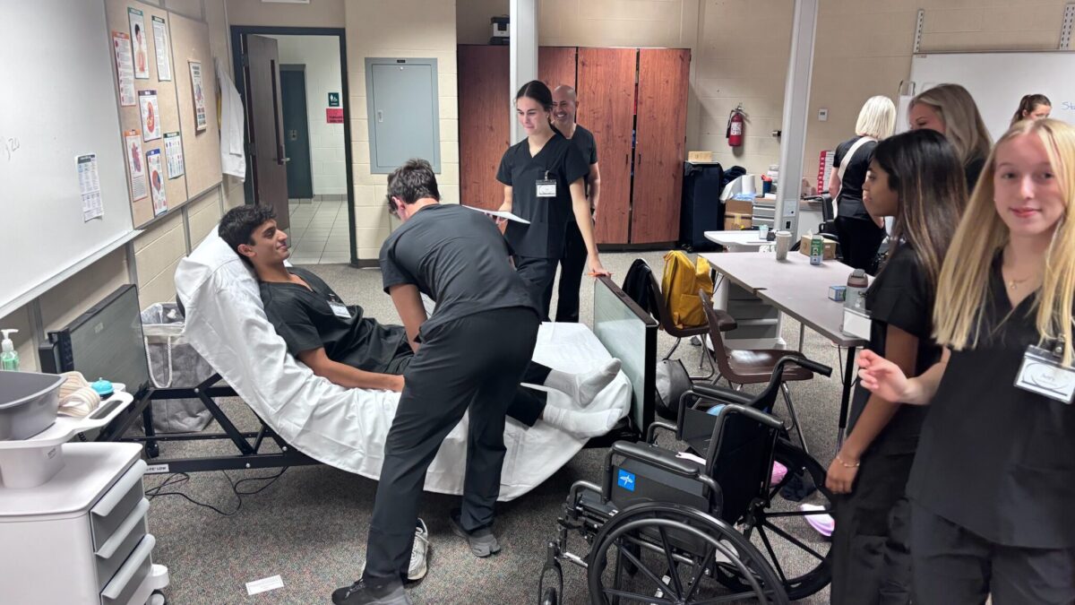 Forest Hills Central students practice patient care skills in a classroom simulation.