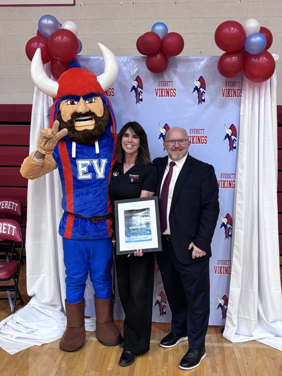 MASSP Executive Director Colin Ripmaster with 2027 Michigan's High School Principal of the Year, Amy Boyles from Everett High School in Lansing with EHS Mascot.
