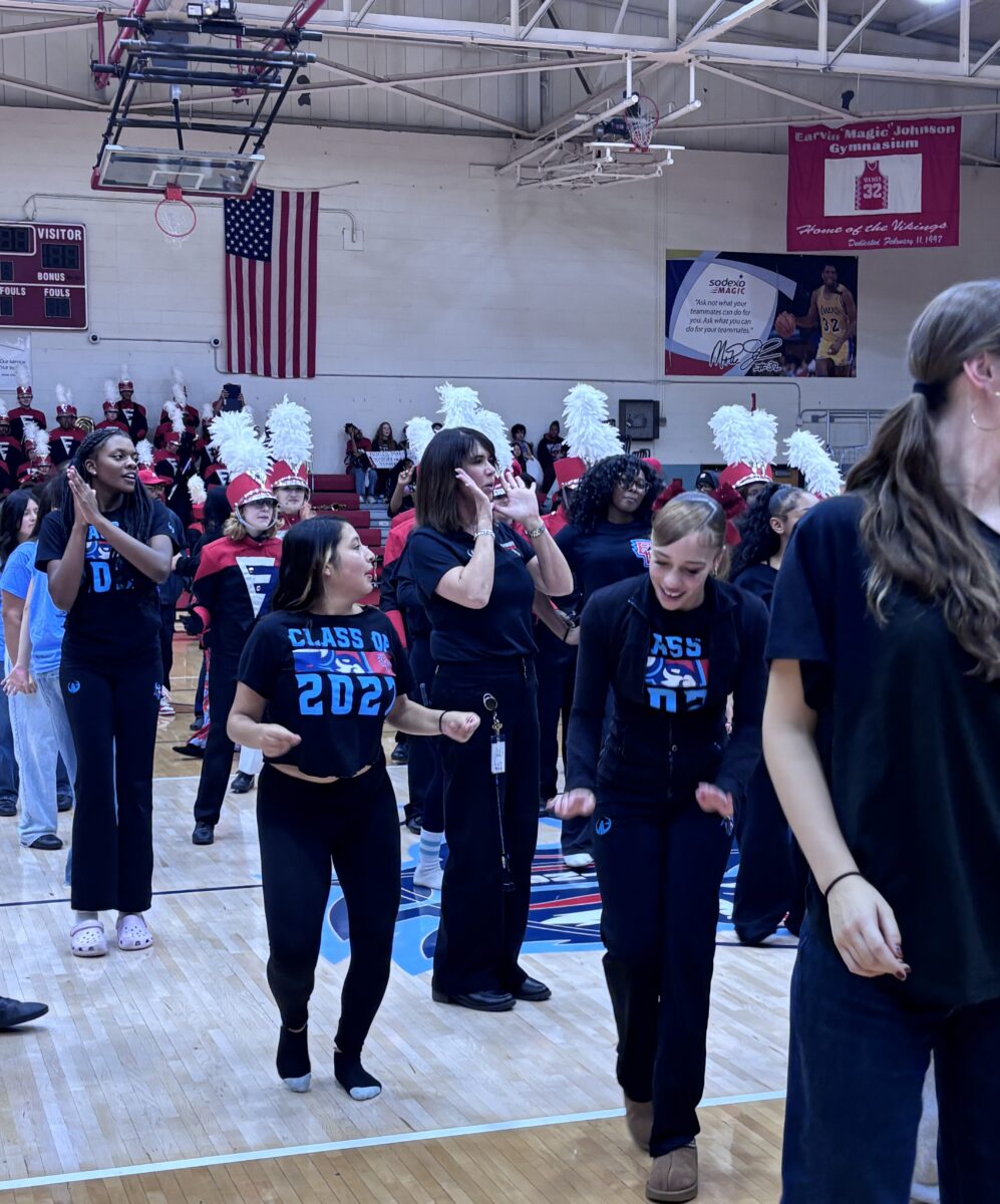 Amy with many students commemorating the special event with the cupid shuffle on the gym floor.