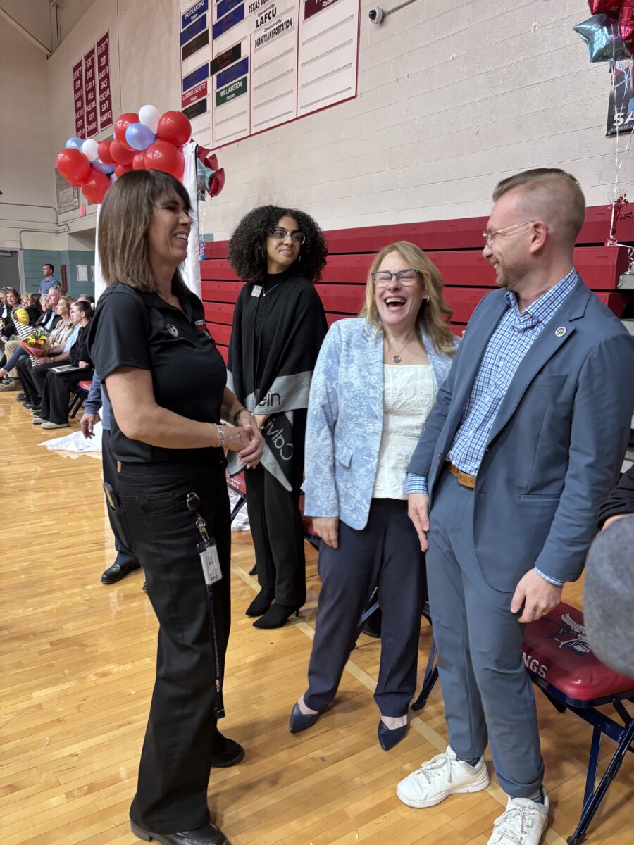 Amy Boyles with Lansing SD Superintendent Jessica Benavides, City Council President Peter Spadafore and Lansing Board of Trustee member chatting and laughing after the celebration.