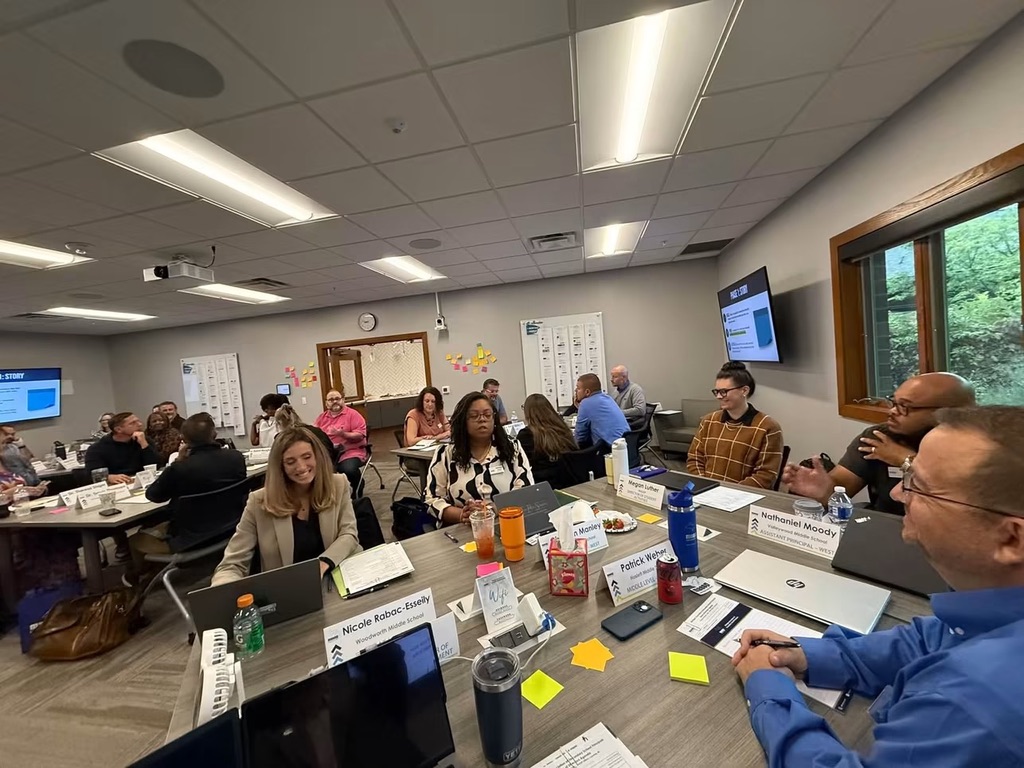 Wide angle shot of a roomful of MASSP board members and staff sitting at tables