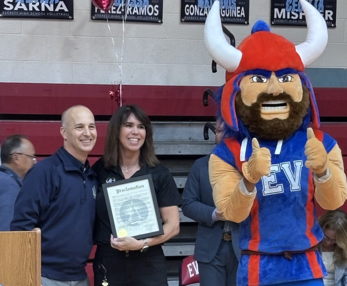 Lansing Mayor Andy Schor and Amy Boyles as he presents a proclamation on behalf of her winning MASSP award.
