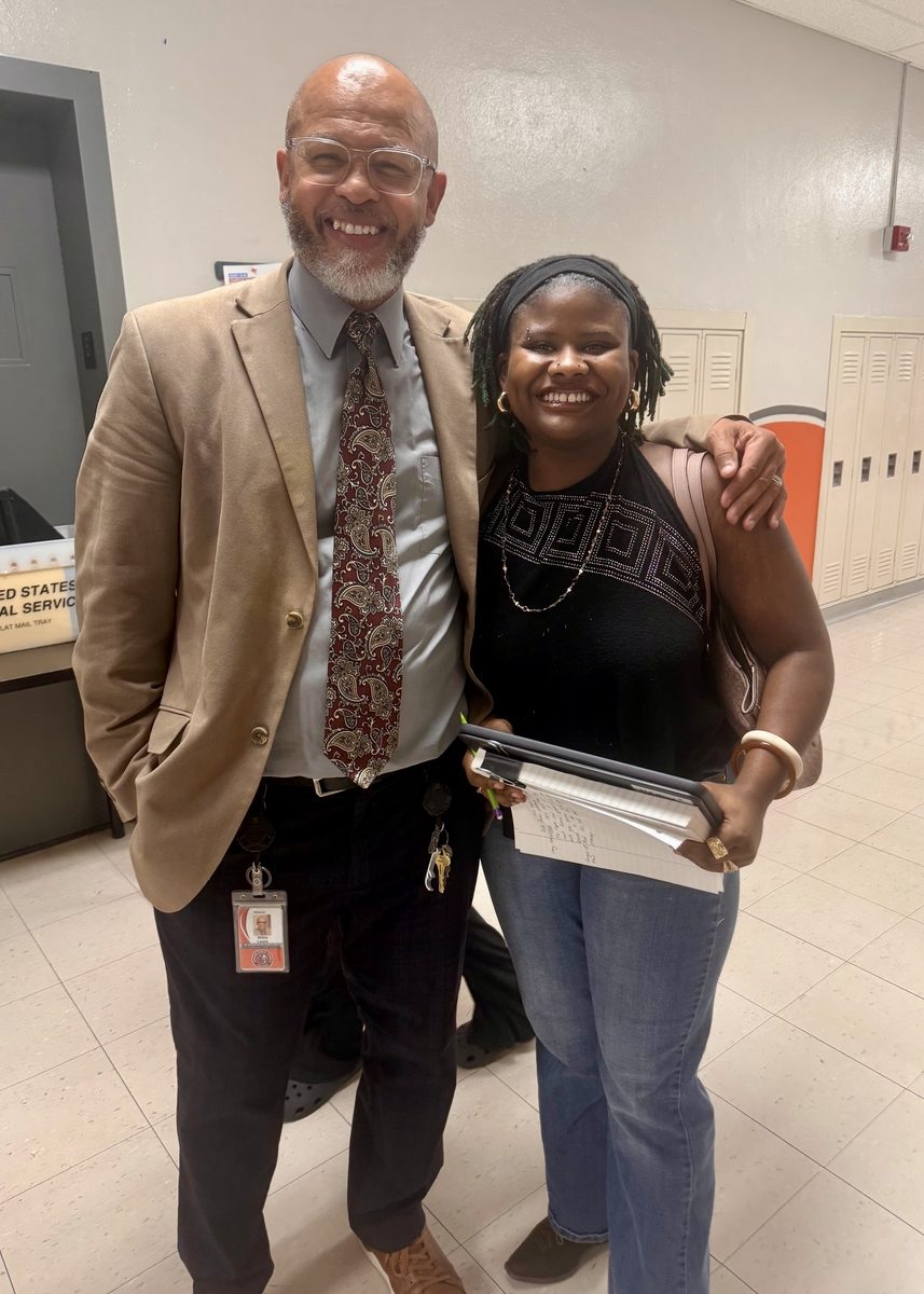 Willie Lewis standing with young female student