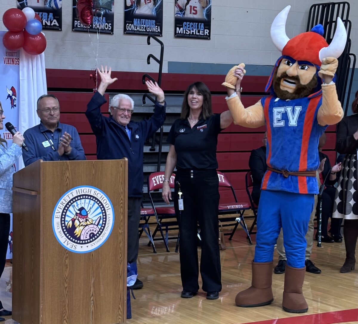 Amy Boyles and EHS Mascot celebrating with Lansing School District Board of Trustee Members.