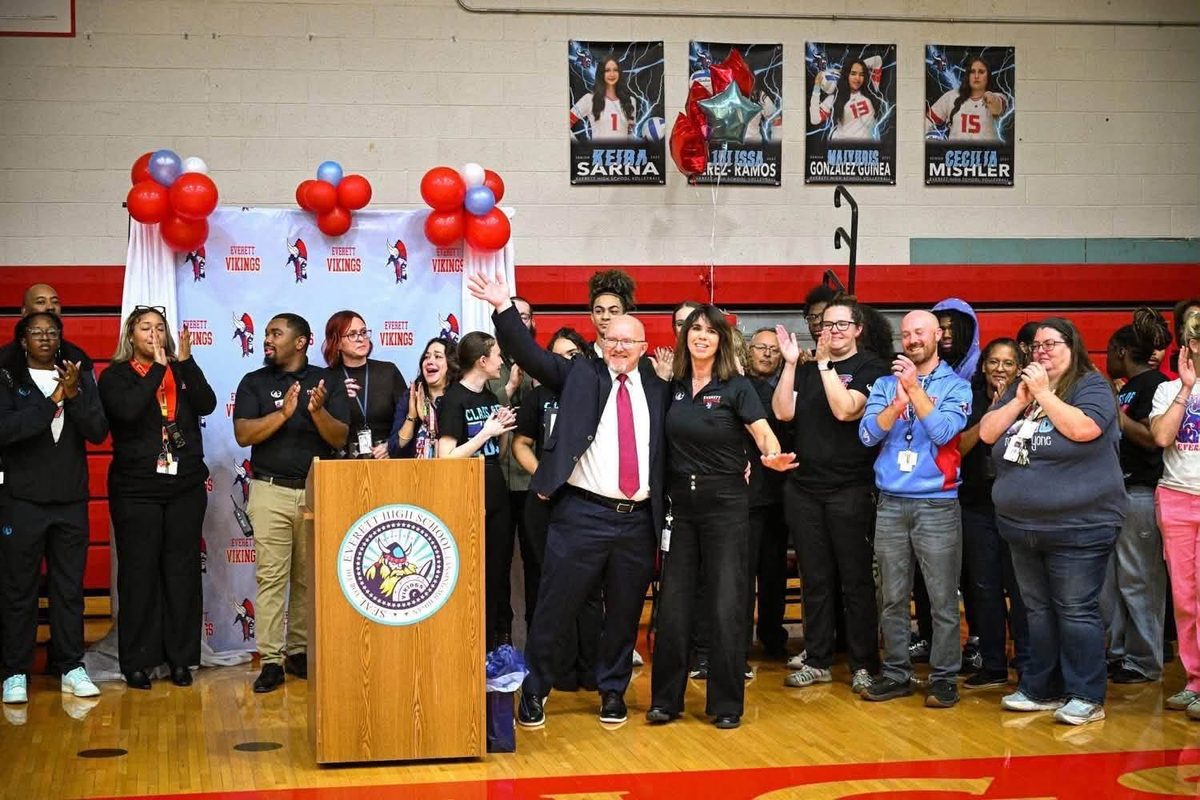 Amy Boyles (EHS Principal and Award Winner) and Colin Ripmaster (MASSP Executive Director) celebrating the announcement of Amy receiving MASSP 2027 Michigan High School Principal of the Year surrounded by staff and guests