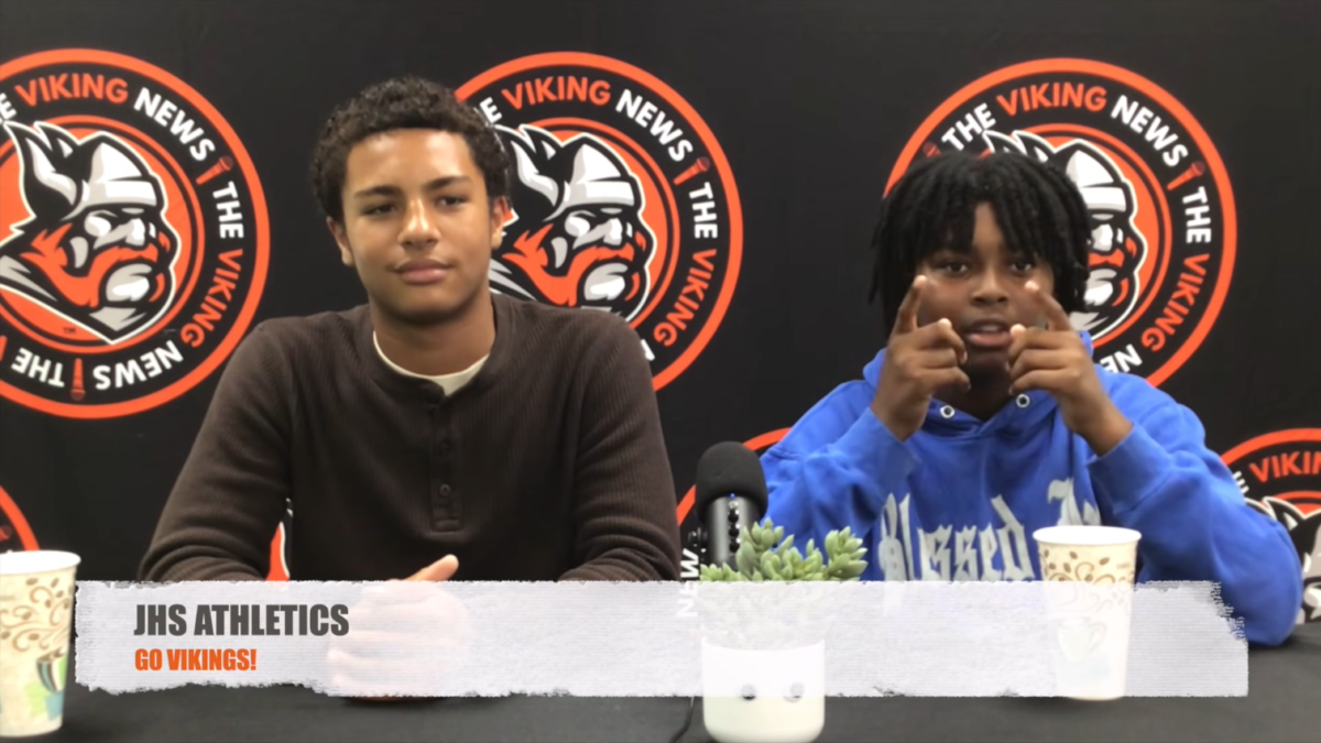 Two television production students providing school news to the camera